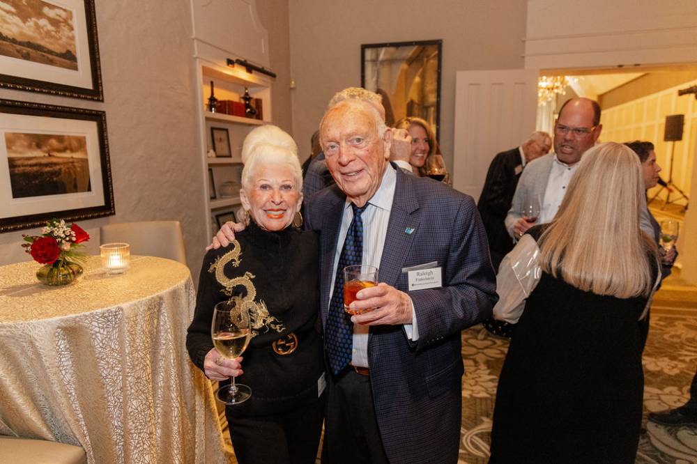 Raleigh Finkelstein and other guest smiling at camera